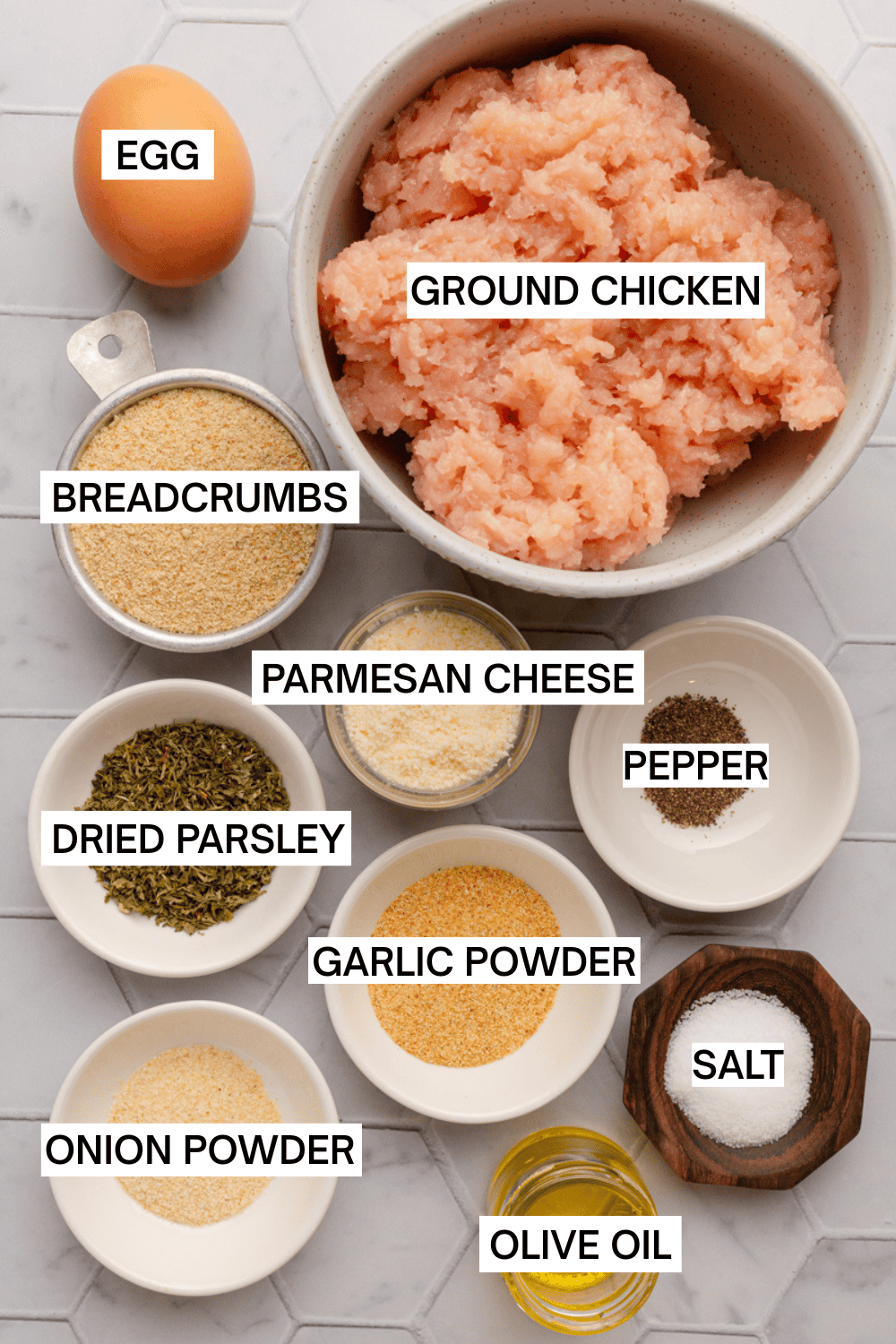 Ingredients for air fryer ground chicken meatballs in bowl with labels over each ingredient.