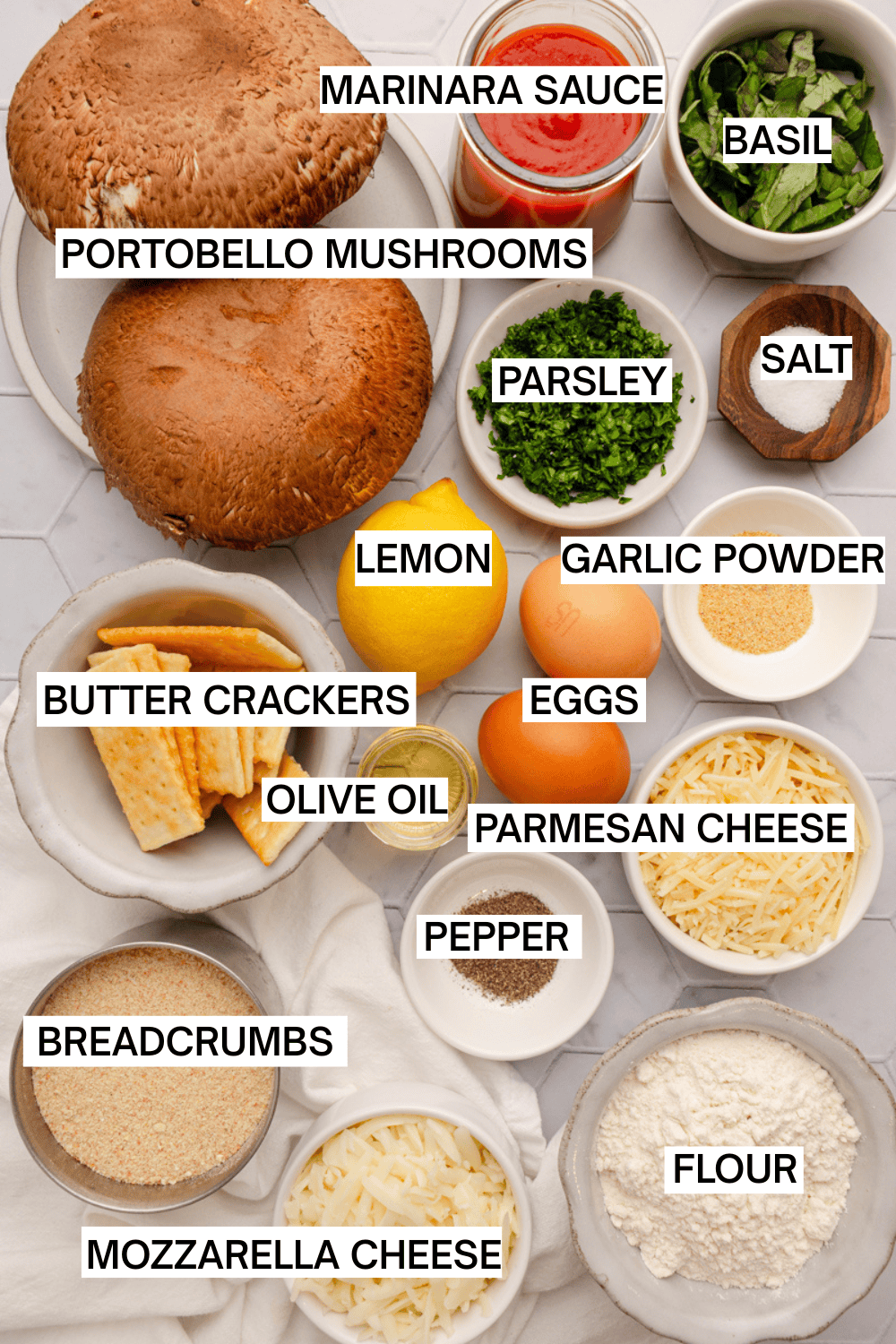 Ingredients for mushroom parmesan in bowls with labels over each ingredient.