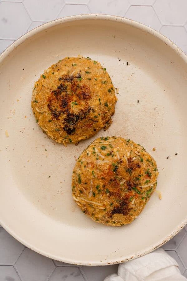 Mushroom parmesan cooking in a pan.