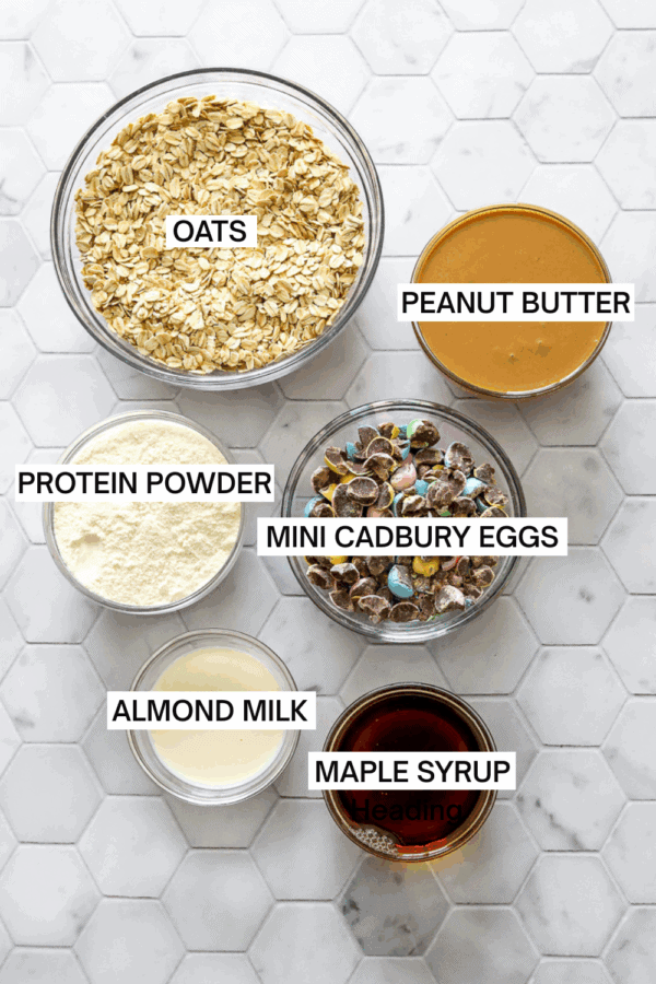 Mini Cadbury egg protein balls ingredients in bowls with labels over each ingredient.
