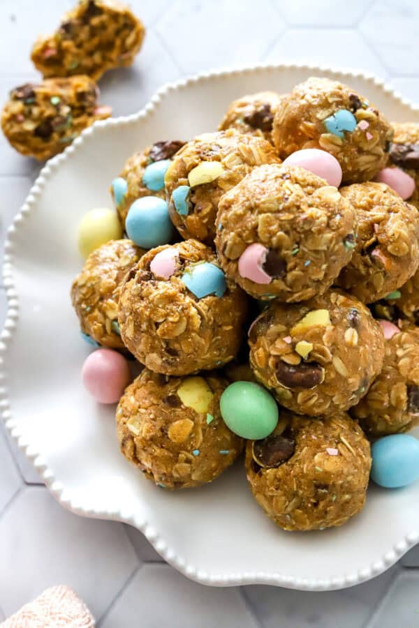 Easter energy bites with chopped chocolate in them on a white plate.