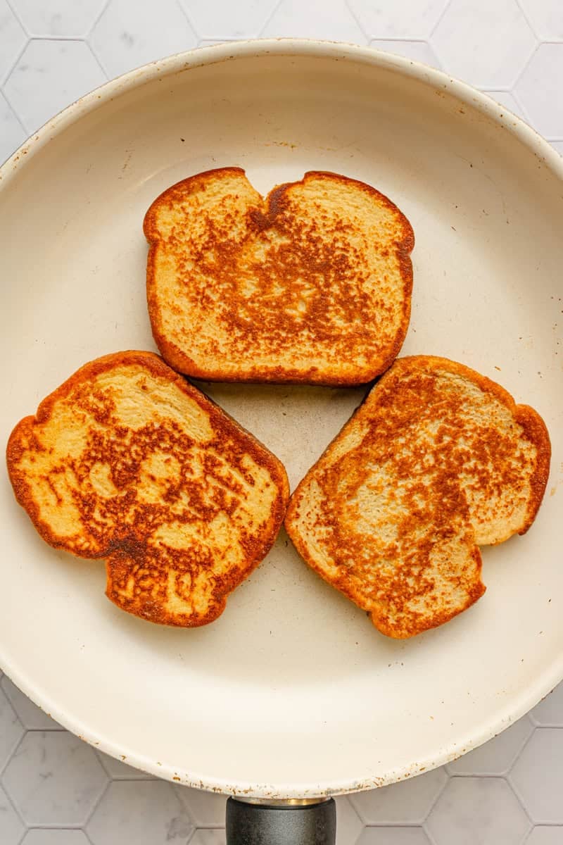 Pan fried French toast in a pan. 