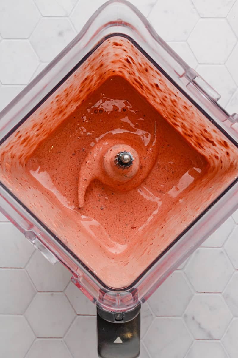 Blended cherry smoothie in blender pitcher.