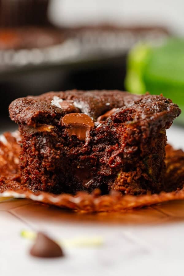 Double chocolate chip muffin with a bite taken out of it.