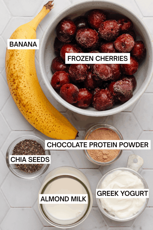 Ingredients for cherry banana smoothie with labels over each ingredient.