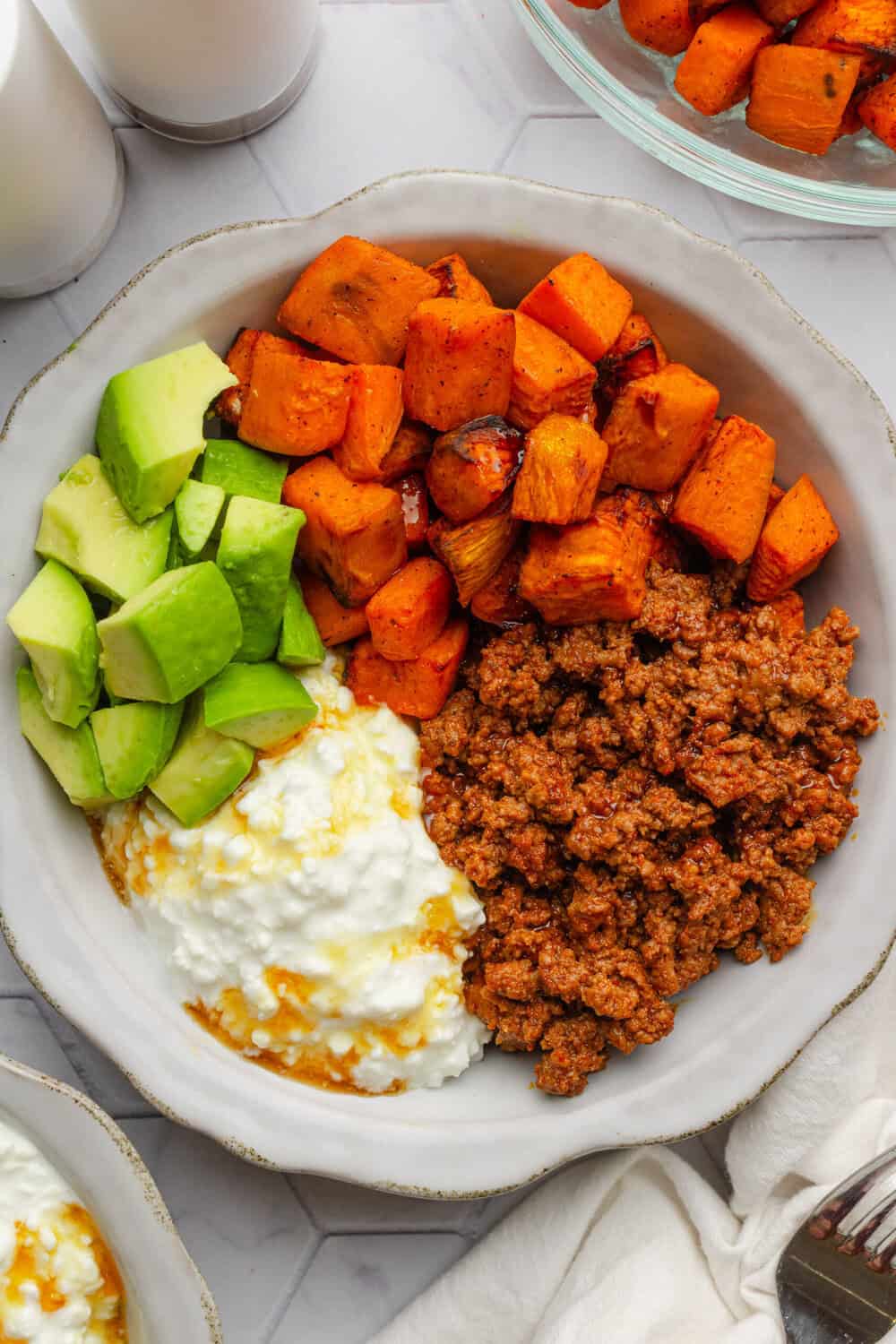 Hot honey ground beef sweet potato bowl with cottage cheese and diced avocado.