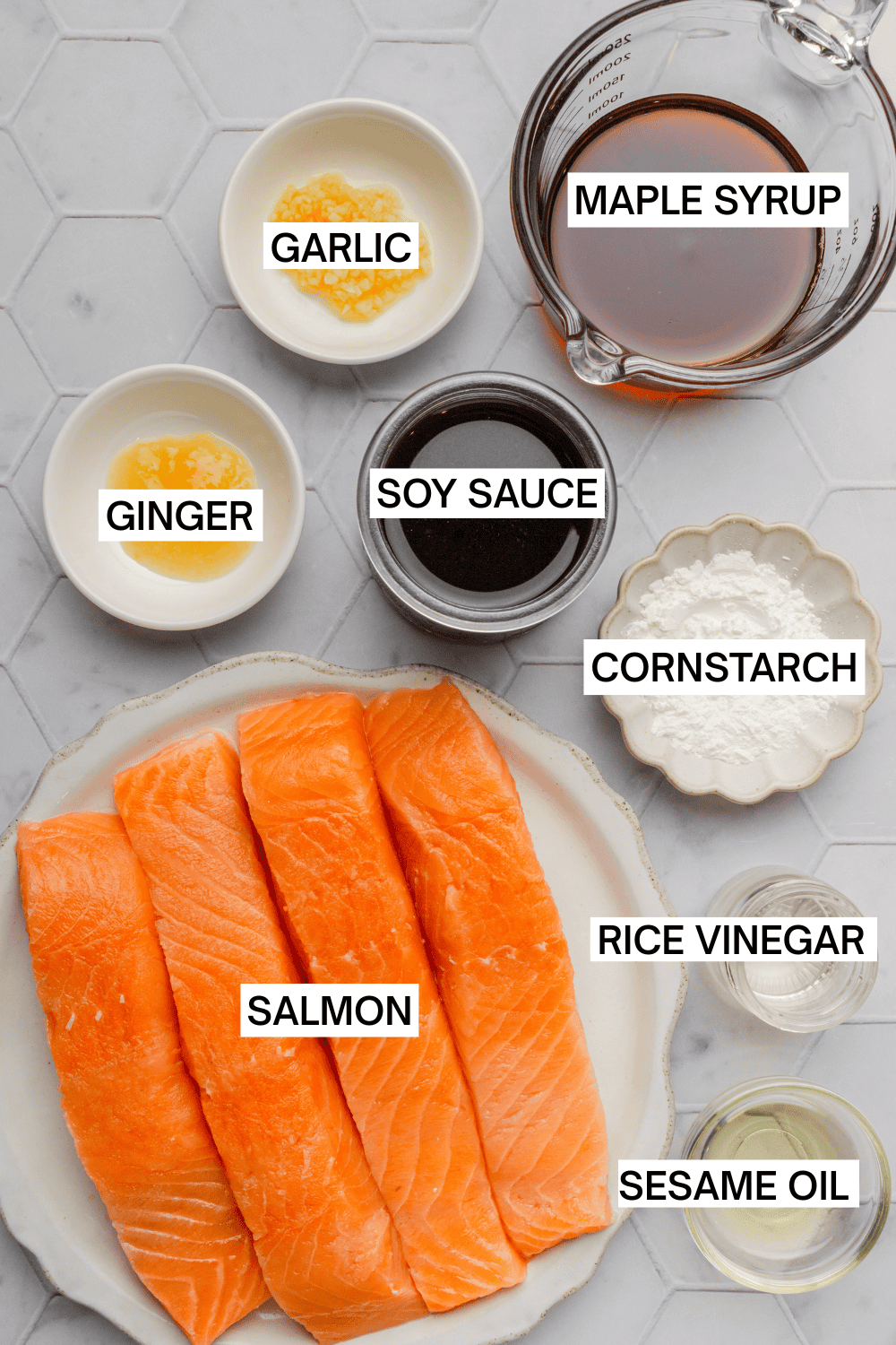 Ingredients for air fryer salmon bites in bowls with labels over each ingredient. 