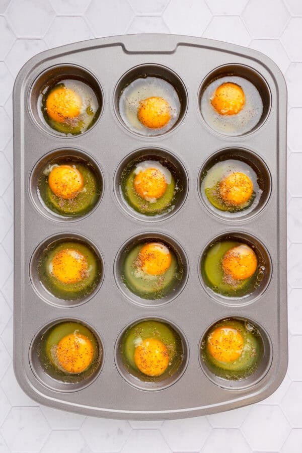 Cracked whole eggs in muffin pan.