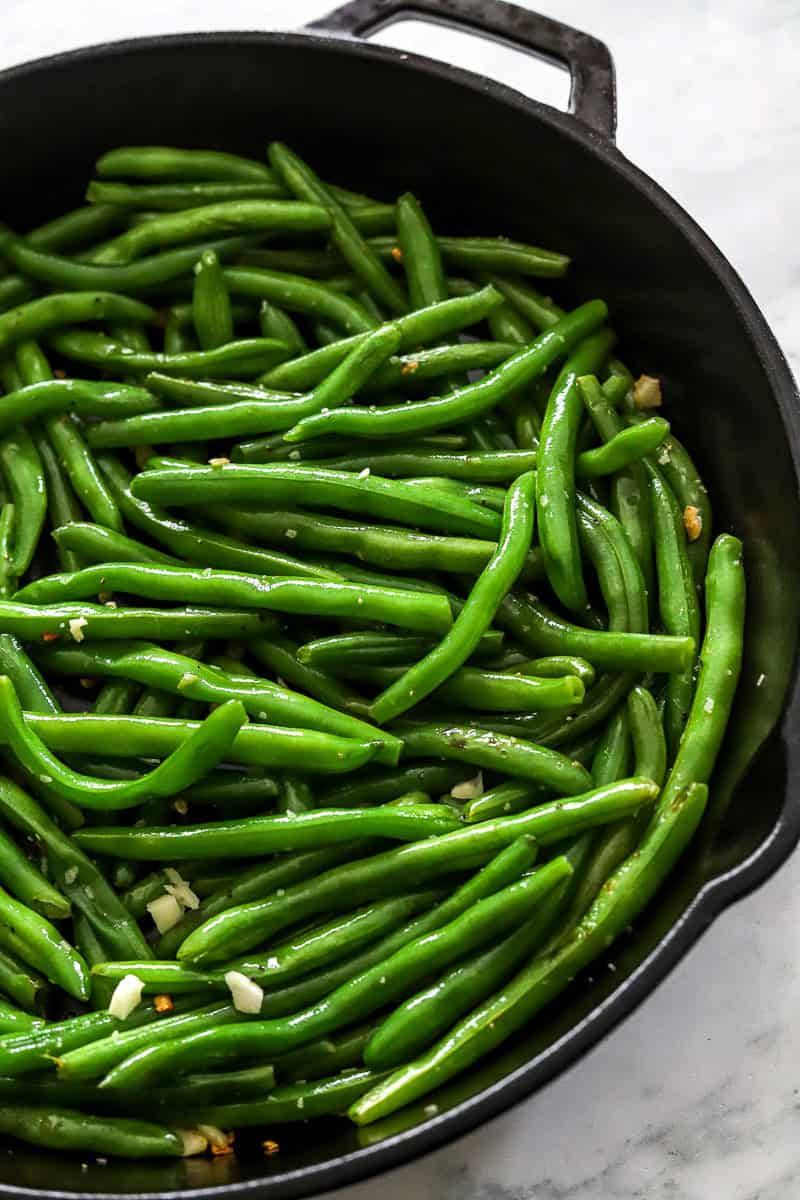 Sauteed green beans in a cast iron pan. 