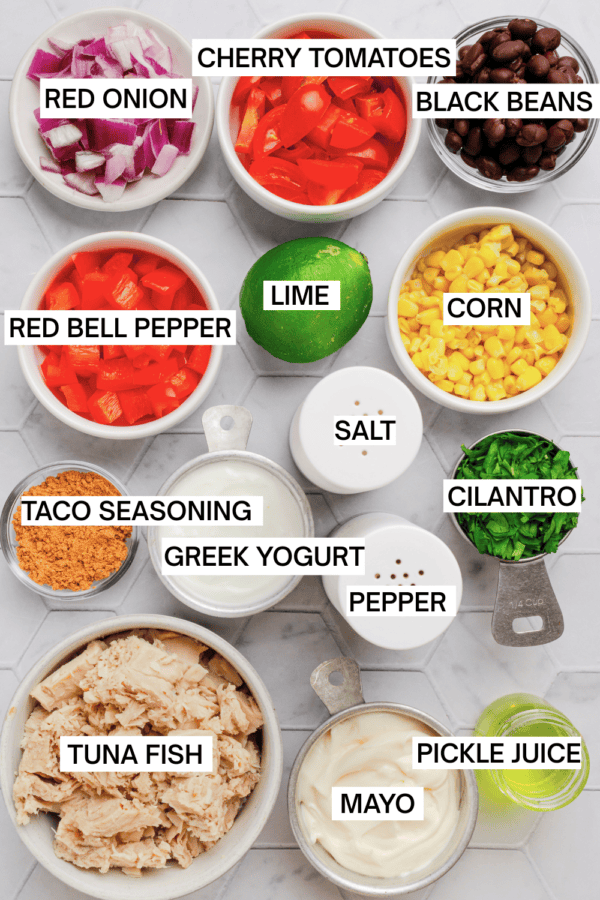 Ingredients for mexican tuna salad in bowls with labels over each ingredient.
