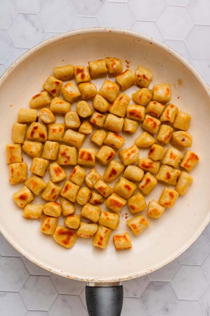Gnocchi cooking in a pan. 