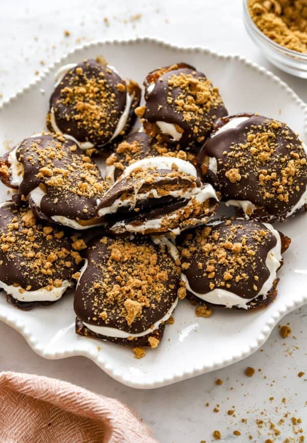 White plate filled with smashed date s'mores.