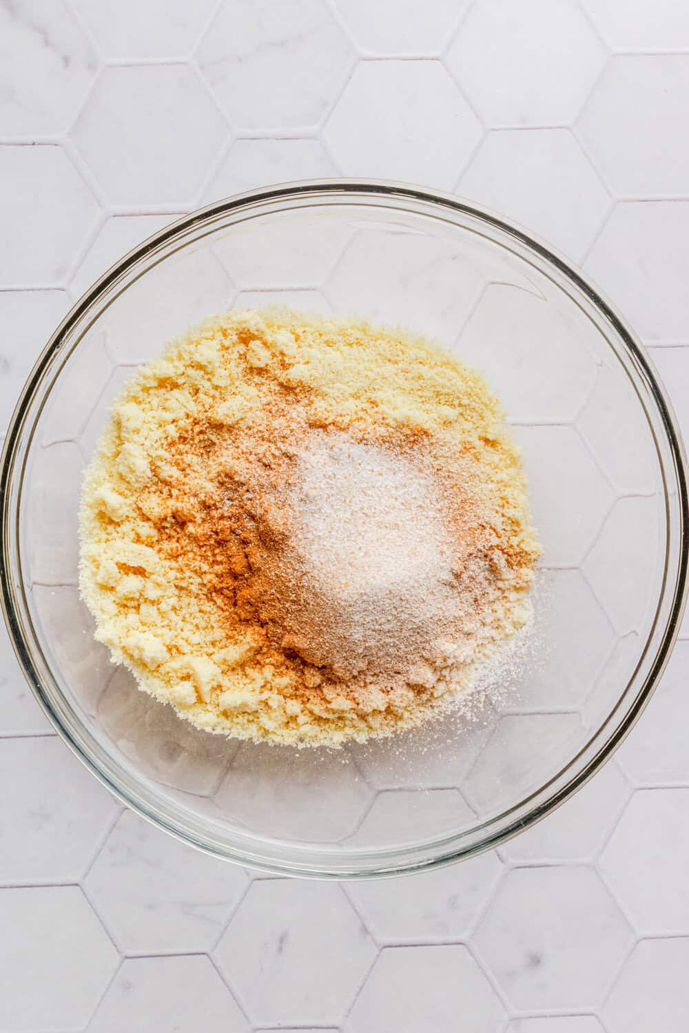 Dry pancake ingredients in a glass mixing bowl. 