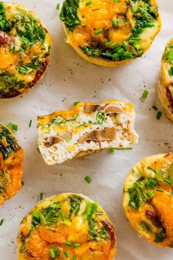 A cut egg white muffin cup with more muffins around it.