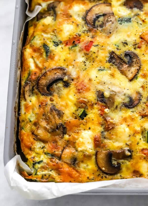 Baking pan filled with cheesy vegetable frittata bake.